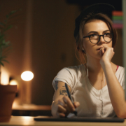 Picture of young concentrated woman designer sitting indoors at