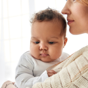 Young Caucasian Mum Hugging Cute Adorable Infant African America